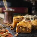 Baklava sweets with nuts on it with coffee and cinnamon
