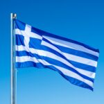 greek-flag-waving-against-blue-sky-background-.jpg